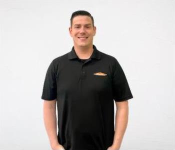 male in a black servpro polo